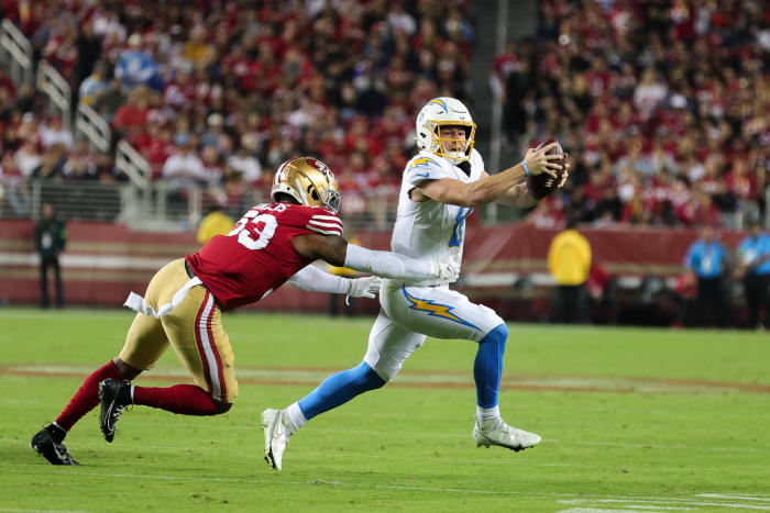 Aug 25, 2023; Santa Clara, California, USA; Los Angeles Chargers quarterback Max Duggan (8) avoids San Francisco 49ers linebacker Dee Winters (53) during the third quarter at Levi's Stadium. Mandatory Credit: Sergio Estrada-USA TODAY Sports